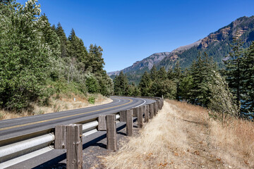 Fototapeta na wymiar Security fence of a winding highway road in the scenic Columbia Gorge National Reserve area