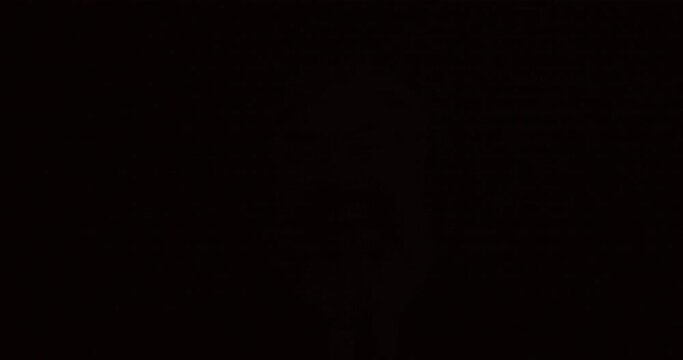 Portrait of crazy mature businessman laughing in bright colorful light flashes in darkness. Excitement ane successful business concept.