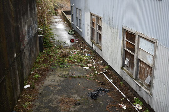 dirty alleyway behind abandoned building