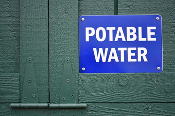 potable water sign posted on green shed