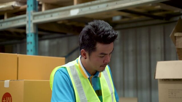 4K, Closeup Asian man, sitting in warehouse, wearing green reflective vest, removed helmet  wearing on head, cool off, and sweat that had accumulated all day. expression and expression were tired,