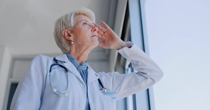 Headache, senior or doctor with stress thinking of healthcare deadlines pressure in hospital or medical office window. Sad, fatigue or tired woman frustrated with doubt, burnout or migraine pain