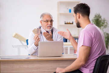 Young male patient visiting old male doctor