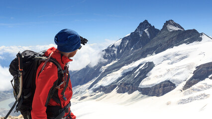 Fototapeta na wymiar Mountaineer looking towards mountain Grossglockner and glacier Pasterze panorama in Glockner Group, Austria