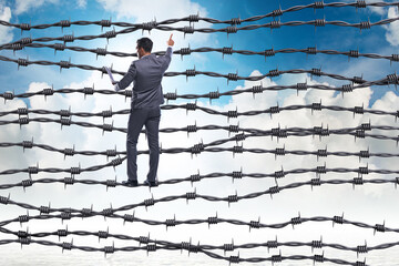 Businessman in barbed wire concept