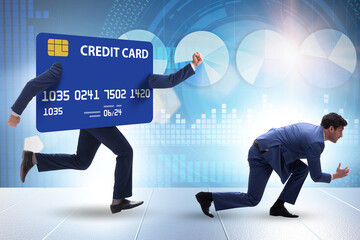 Businessman in the credit card debt concept
