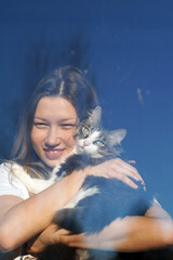 A teenage girl is reflected in the window in sunny weather. Psychology