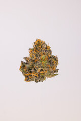 Obraz premium Single Dried Cannabis Nug on White Background