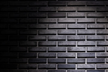 Black brick wall background with light spot