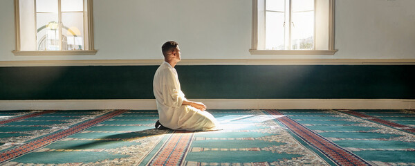 Mosque, worship and muslim man in prayer on his knees for gratitude, support or ramadan for...