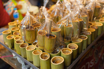 Thai street food in temple fair, and night local markets in Bangkok. Asian Retail shops. Travel in Thailand.