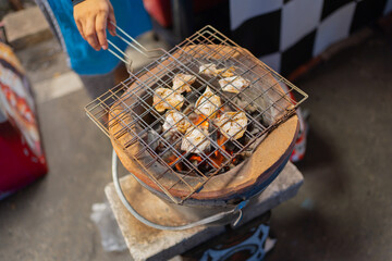 Thai street food in temple fair, and night local markets in Bangkok. Asian Retail shops. Travel in Thailand.