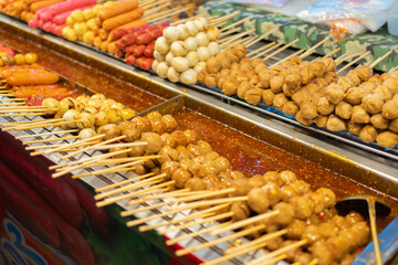 Thai street food in temple fair, and night local markets in Bangkok. Asian Retail shops. Travel in Thailand.