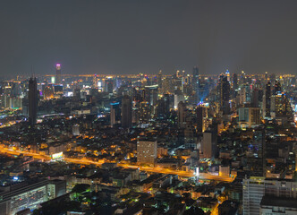 Fototapeta premium Aerial view of Bangkok Downtown Skyline, Thailand. Financial district and business centers in smart urban city in Asia. Skyscraper and high-rise buildings at night.