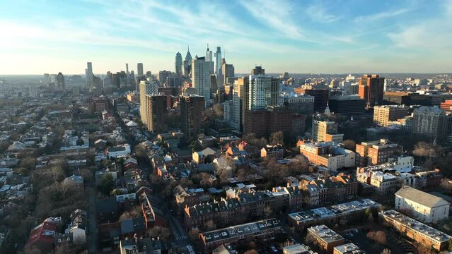 Residential district with urban city skyline during golden hour. Philadelphia Pennsylvania USA establishing shot during winter.