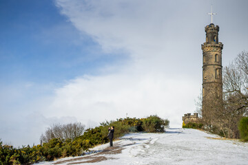 Fototapeta premium Calton Hill , Nelson Monument and Cityscape view of Edinburgh old town numerous attractions around during winter snow at Edinburgh , Scotland : 28 February 2018