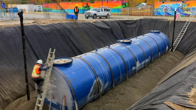 Construction of New Gas Station: Underground Fuel Storage Tank Filled with Pea Gravel by Rock Slinger Truck