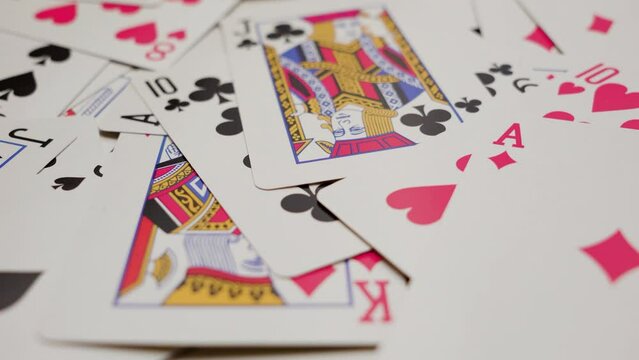 Scattered playing cards on a table. Close up