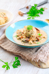 Homemade Bavarian bread dumpling with creamed mushroom sauce