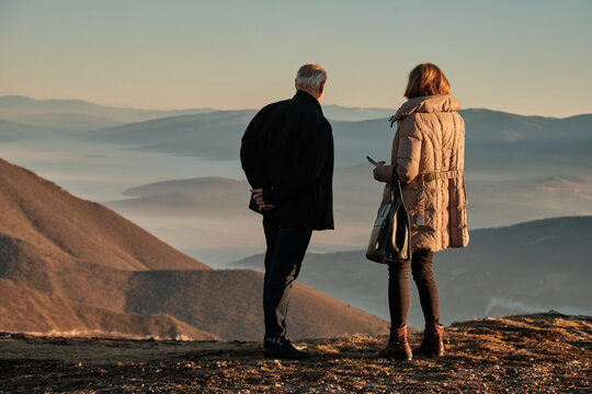 A Senior Couple Enjoying In View From The Mountain Top.