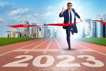 Businessman running to new 2023 year