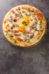 Italian Pizza carbonara Contains egg yolk, cream, bacon, parmesan and Mozzarella cheese closeup. Vertical top view from above