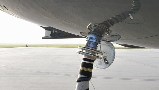 Air Start Unit (ASU) Discharge Air Hose Attached To Aircraft Underbelly, Starting Jet Engine On The Airfield. closeup