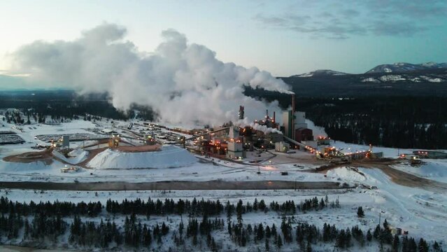 Winter Sunrise at Pulp Mill in Cranbrook, British Columbia: Aerial View of Industrial Facility and Specialized Machinery Processing Raw Materials for Paper Production