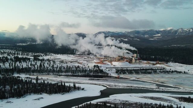 Pulp Mill in Action: Aerial View of Industrial Facility in Cranbrook, British Columbia Processing Raw Materials for Paper Production on a Winter Morning