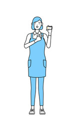 クレジット決済を勧めるエプロンを着た女性