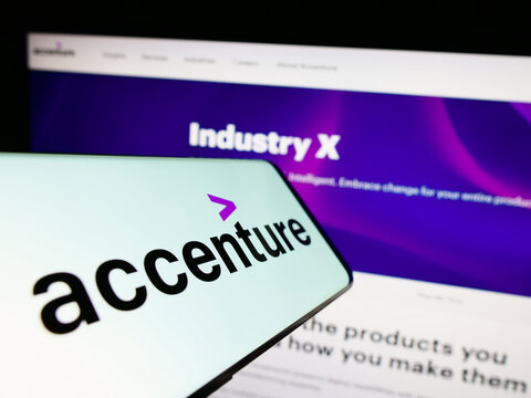 Stuttgart, Germany - 12-23-2022: Mobile phone with logo of information technology company Accenture plc on screen in front of website. Focus on center-right of phone display.
