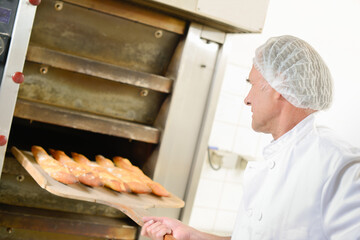 Taking bread out of the oven