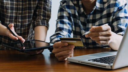 Hands holding credit card and using laptop. Online shopping