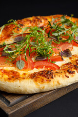 Napoli pizza with herbs on wooden cutting board