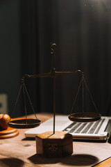 Business and lawyers discussing contract papers with brass scale on desk in office. Law, legal services, advice, justice and law concept picture with film grain effect