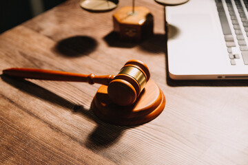 Business and lawyers discussing contract papers with brass scale on desk in office. Law, legal services, advice, justice and law concept picture with film grain effect