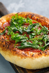 Napoli pizza with herbs on wooden cutting board