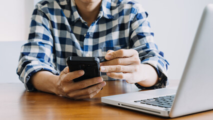 Fototapeta premium Hands holding credit card and using laptop. Online shopping