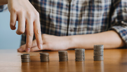 businessman holding coins putting in glass with using calculator to calculate concept saving money for finance accounting, Business, finance, investment, Financial planning.