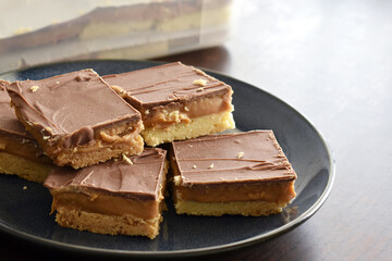 Millionaire's shortbread with chocolate and caramel on a plate.