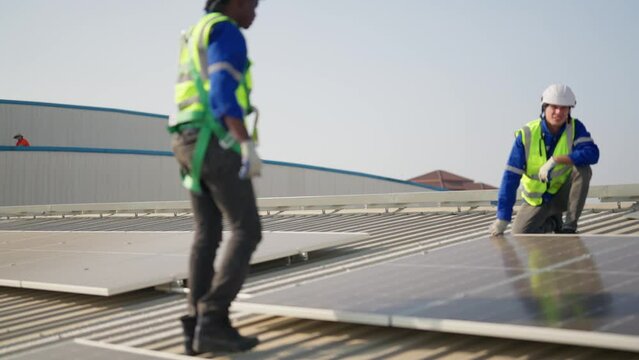 Engineer on rooftop sitting next to solar panels photo voltaic check alignment for good installation