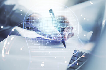 Naklejka premium Double exposure of creative artificial Intelligence symbol with hand writing in notebook on background with laptop. Neural networks and machine learning concept
