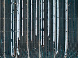 Aerial shots of multiple high-speed trains parked on railway tracks