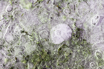Artistic and abstract composition with a frozen soil. The ice makes bubbles over the colored soil and sand. Berat, Albania.