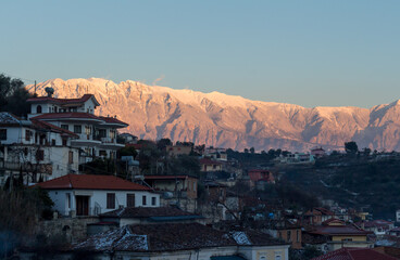 Fototapeta premium Beautiful panorama of Berat by sunset in winter, with mountains covered with snow in the background, Albania.