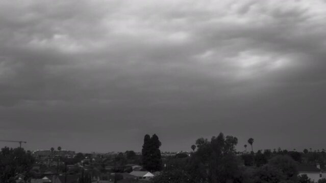 Timelapse clouds dump rain onto Los Angeles in monochrome.