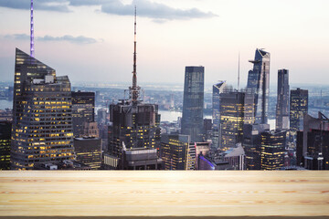 Blank wooden tabletop with beautiful New York skyline at night on background, mockup