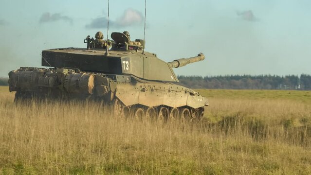 rear quarter profile of British army FV4034 Challenger 2 ii main battle tank in action on a military combat exercise, Wiltshire UK