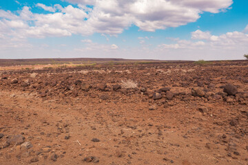 A dirt road in the panoramic desert landscapes of Loiyangalani District in Turkana, Kenya