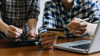 Hands holding credit card and using laptop. Online shopping